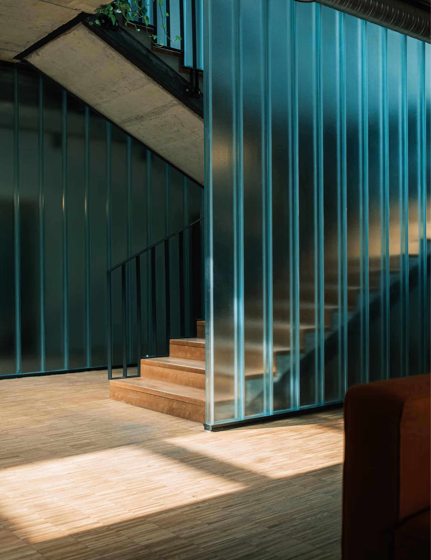 An interior staircase with a glass wall on the sides